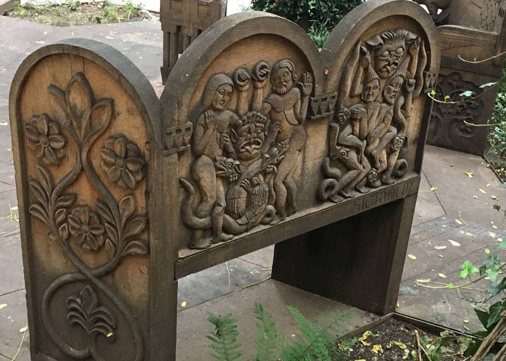 A engraved bench with medieval characters on it
