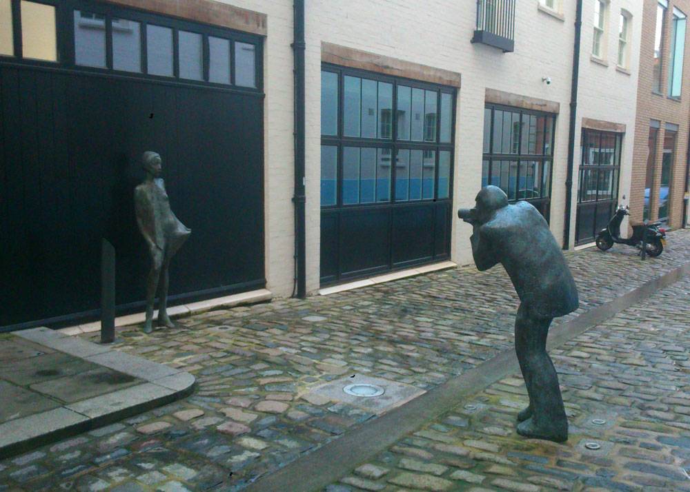 Statues of a man using a camera in Mayfair
